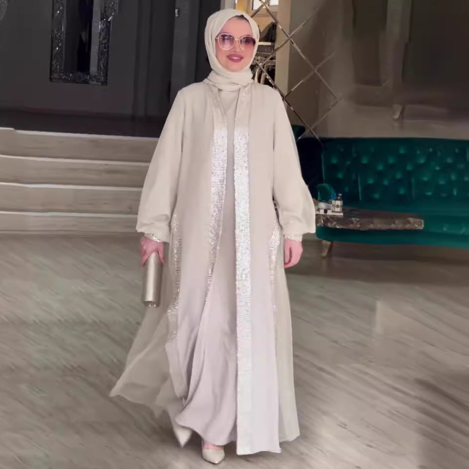 فستان فضفاض بأكمام طويلة ولون مشمشي سادة مزين بحلي لامعة