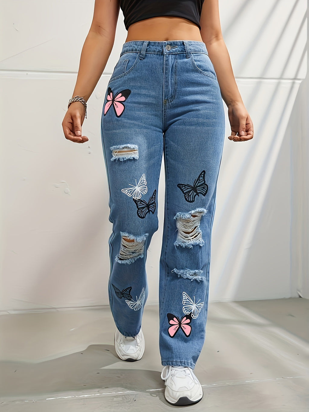 Jean droit taille haute en denim bleu pour femme avec imprimé papillon et déchirures usées