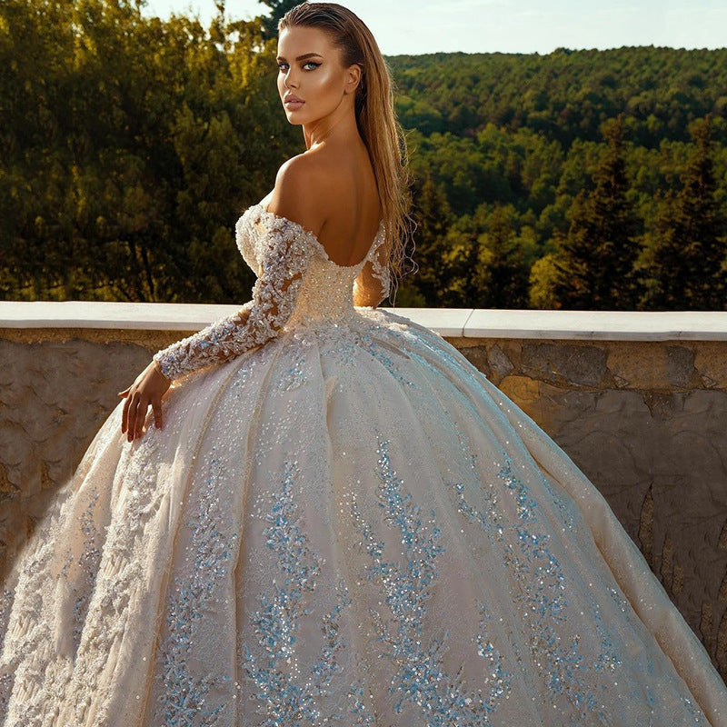 Robe de mariée longue brillante à paillettes et manches longues avec dos nu