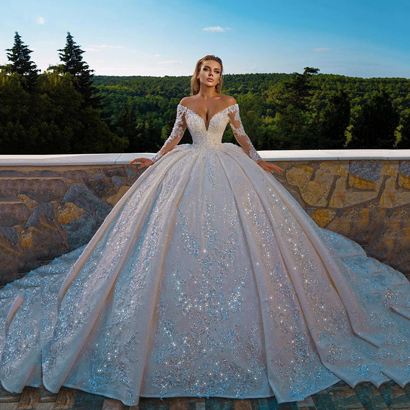 Robe de mariée longue brillante à paillettes et manches longues avec dos nu
